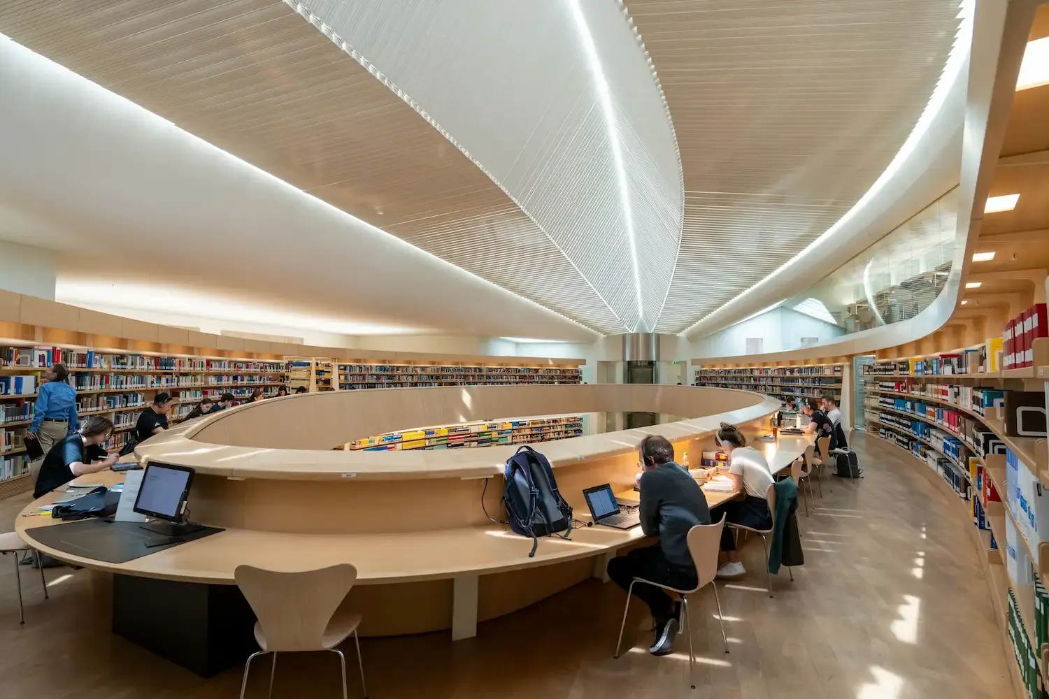 Interior of a modern library with people working.